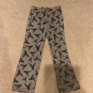 Cozy gray pajama pants with a playful reindeer print. Perfect for sleeping